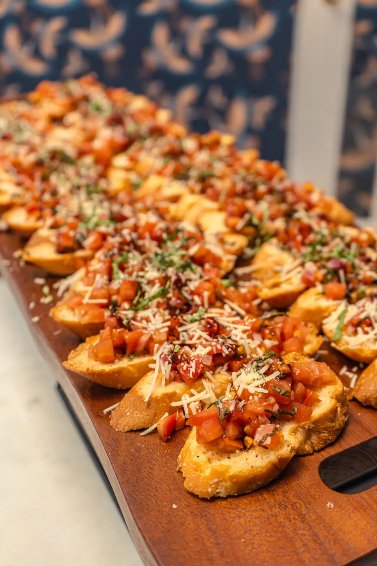 Bruschetta crostini topped with tomato and shaved parmesan