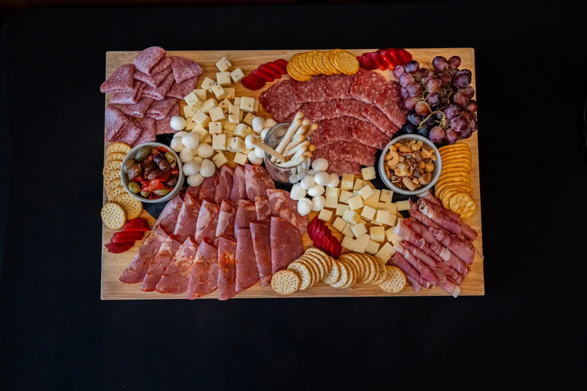 Charcuterie platter with meats, cheeses, olives and crackers for corporate catering